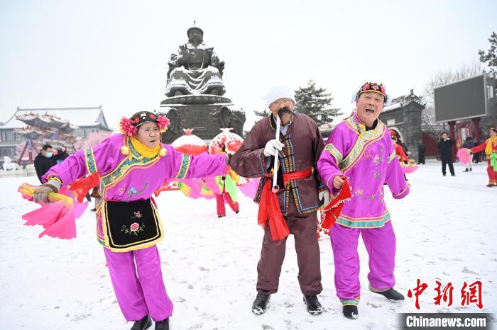 2月13日，秧歌隊在呼和浩特市大召廣場雪中起舞?！⑽娜A 攝