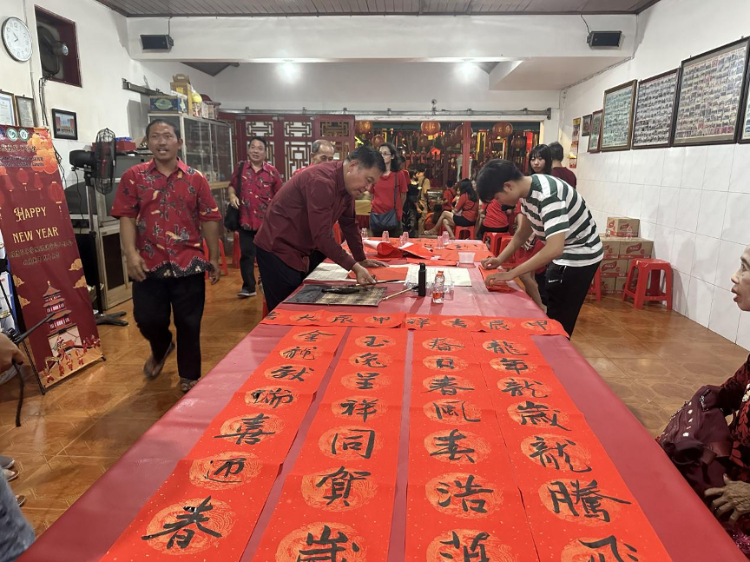 茍皓東為華人朋友現(xiàn)場寫春聯(lián)送福字。巴陵康孔子學(xué)院供圖