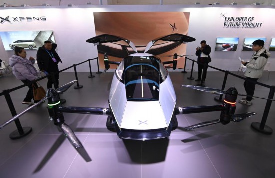 2023年12月1日，在鏈博會(huì)智能汽車鏈展區(qū)小鵬汽車展臺(tái)，參觀者觀看一臺(tái)智能飛行器。新華社記者蔡湘鑫攝