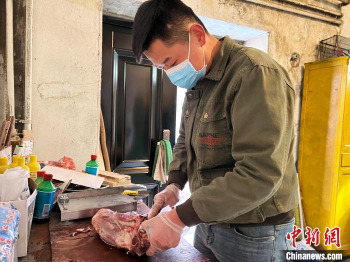 圖為雪豹“奶爸”史壽軍正在準備投喂雪豹的食材?！●R銘言 攝