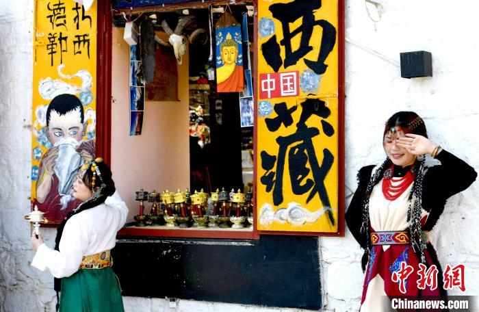 4月17日，游客身著藏式元素服裝在拉薩八廓街拍照留念?！±盍?攝