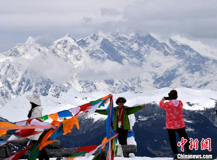 圖為5月14日，西藏林芝色季拉山觀景臺(tái)，游客與南迦巴瓦峰合影?！±盍?攝